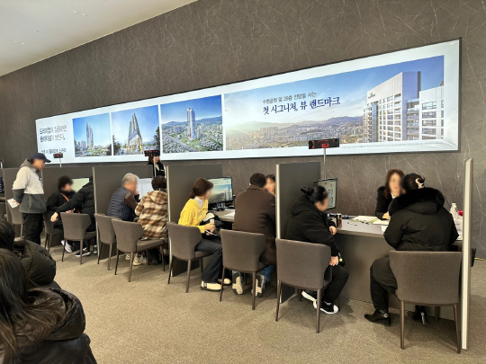 지난 22일 문을 연 '쌍용 더 플래티넘 스카이' 견본주택에 방문객들이 모형도를 관람하고 있다.   [쌍용건설 제공]